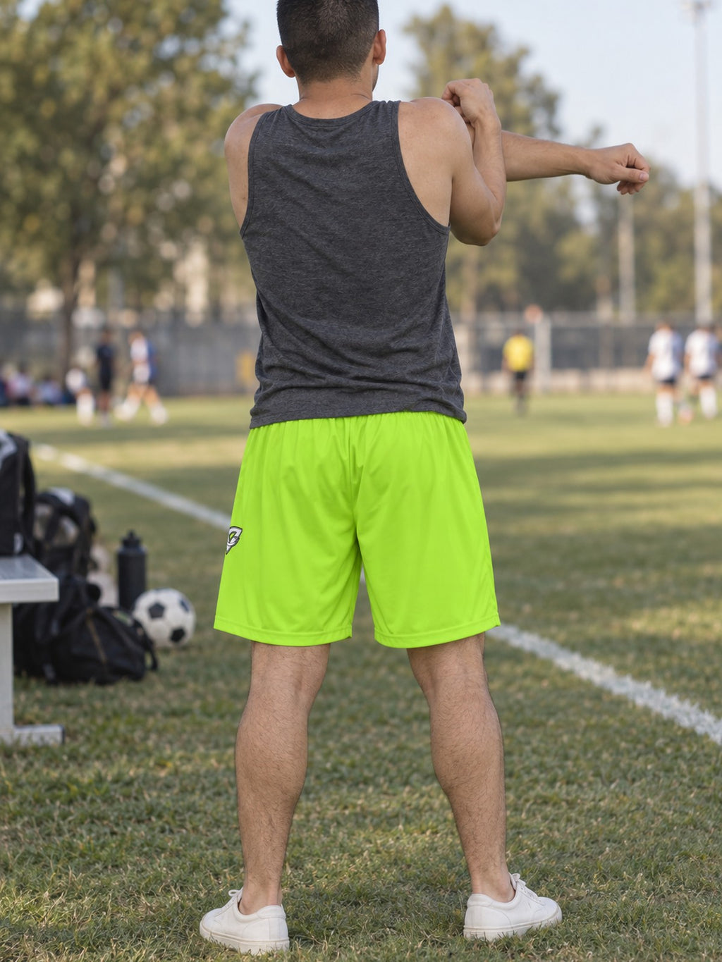 Man wearing the Men's Volt Green Essential Athletic Sports Shorts