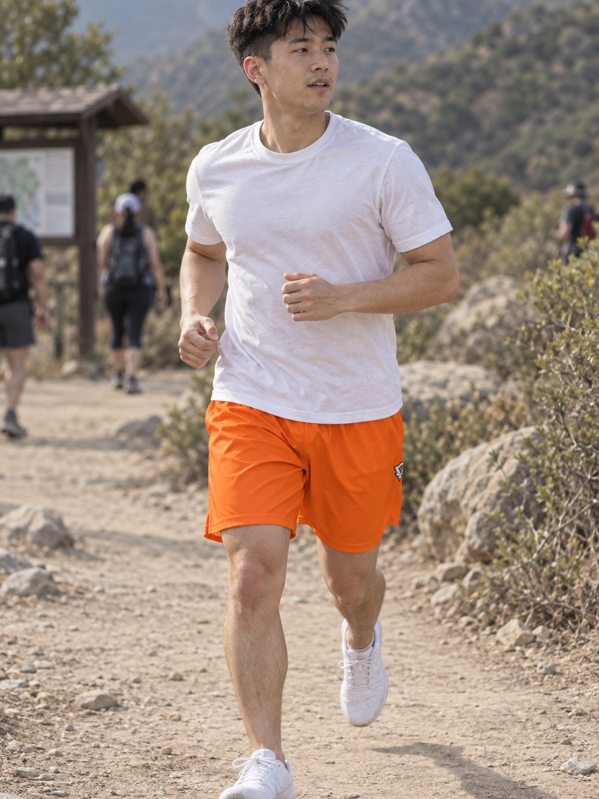 Man wearing the Men's Blaze Orange Essential Athletic Sports Shorts