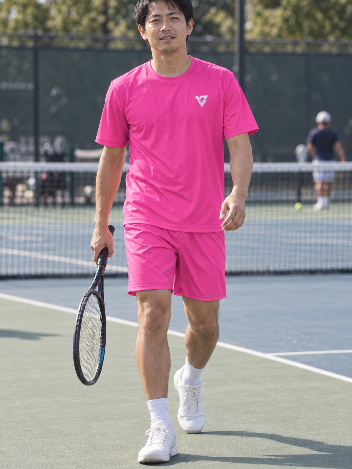 Man wearing the Electric Pink Essential men's matching set – athletic shirt and multipurpose shorts – front view