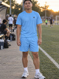 Man wearing the Sky Blue Essential men's matching set – athletic shirt and multipurpose shorts – front view