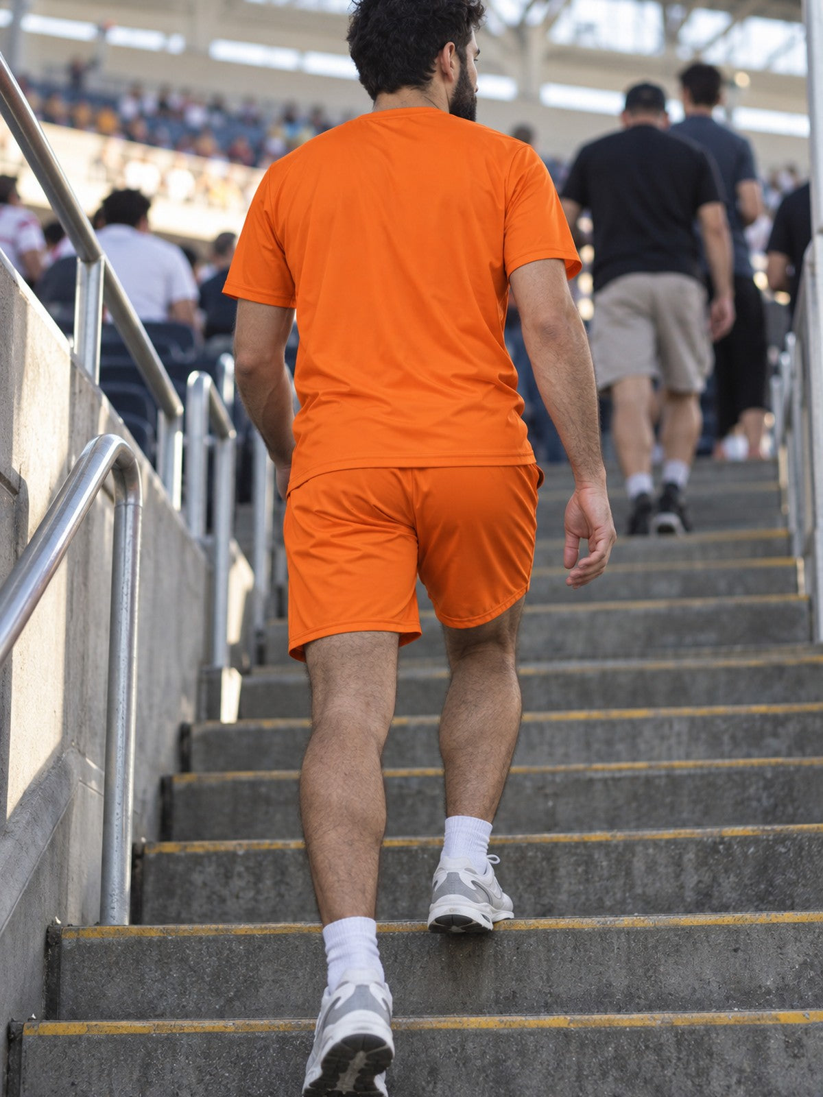 Man wearing the Blaze Orange Essential men's matching set – back view