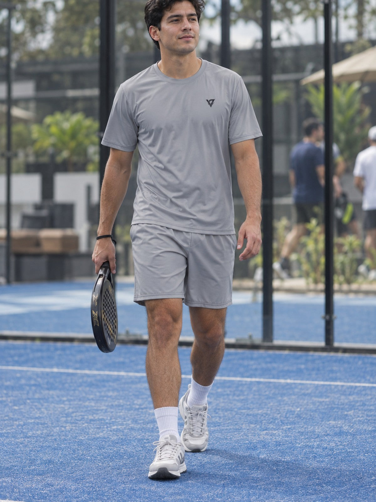 Man wearing the Stone Grey Essential men's matching set – athletic shirt and multipurpose shorts – front view