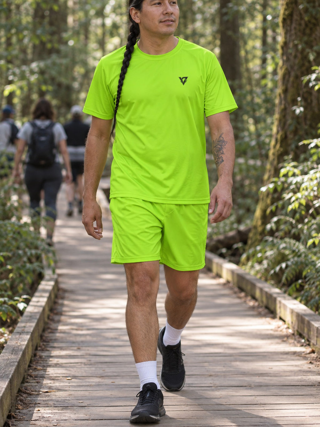 Man wearing the Volt Green Essential men's matching set – athletic shirt and multipurpose shorts – front view