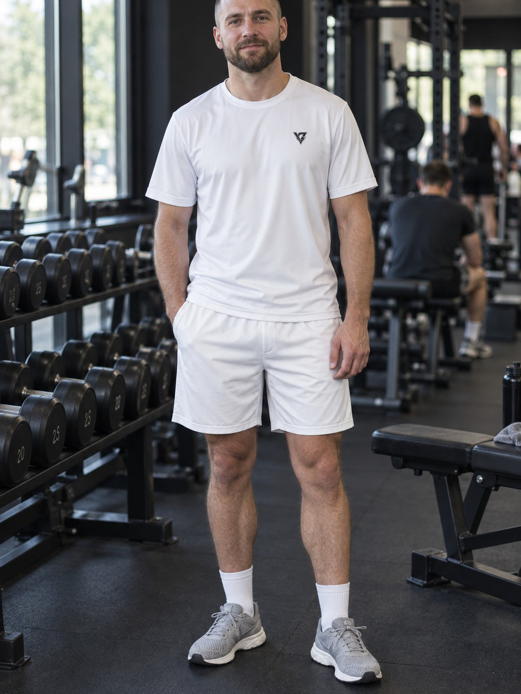 Man wearing the Arctic White Essential men's matching set – athletic shirt and multipurpose shorts – front view