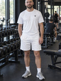 Man wearing the Arctic White Essential men's matching set – athletic shirt and multipurpose shorts – front view