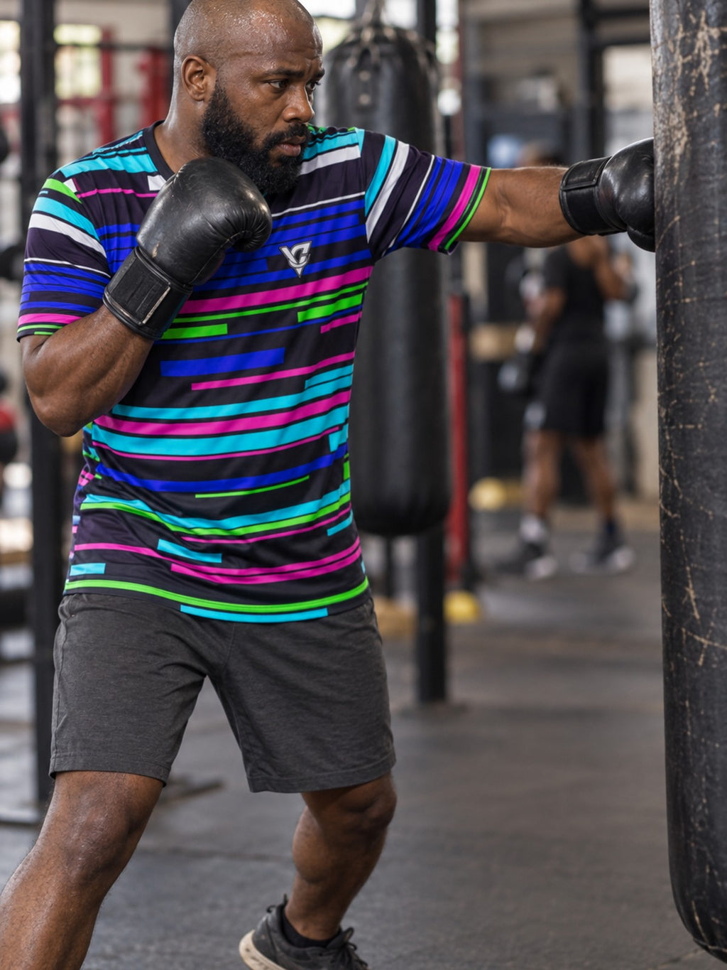Man training in the Glitch Signal men's sports jersey with the Vantacore V emblem on the left chest – side view