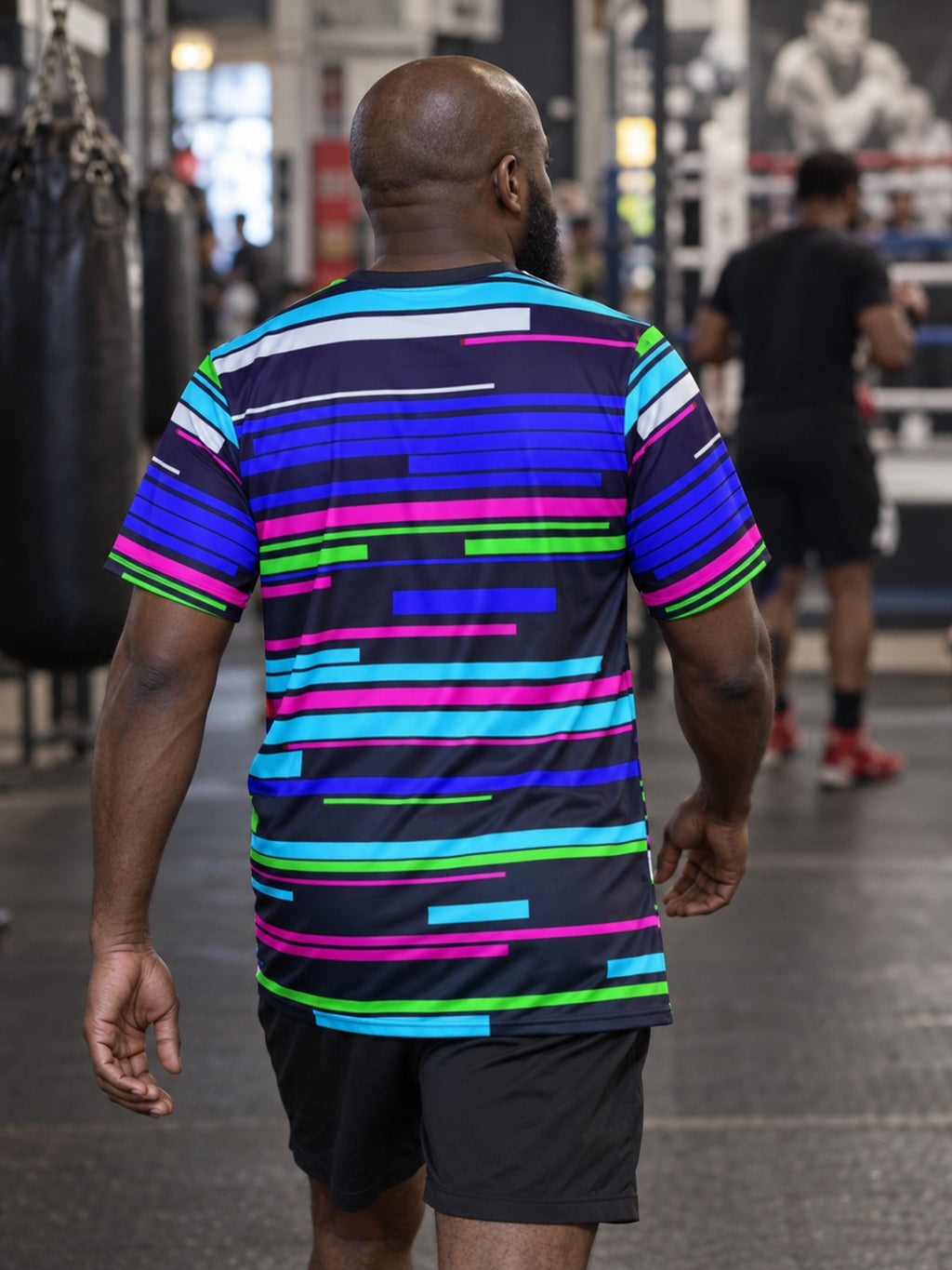Man training in the Glitch Signal men's sports jersey with the Vantacore V emblem on the left chest – back view