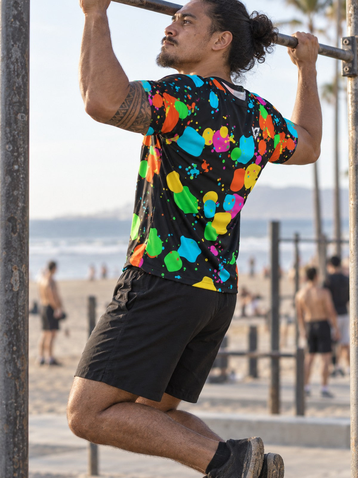 Man training in the Neon Splatter men's sports jersey with the Vantacore V emblem on the left chest – side view
