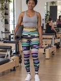 Woman wearing the Pastel Glitch high-waisted yoga leggings with the Vantacore V emblem on the hip – front view