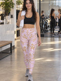 Woman wearing the Rose Quartz Marble high-waisted yoga leggings with the Vantacore V emblem on the hip – front view