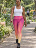 Woman wearing the Sunrise Burst high-waisted yoga leggings with the Vantacore V emblem on the hip – front view