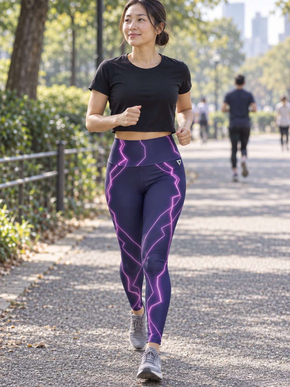 Woman wearing the Pink Lightning high-waisted yoga leggings with the Vantacore V emblem on the hip – front view