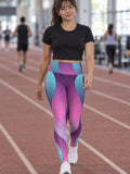 Woman wearing the Vaporwave Wave high-waisted yoga leggings with the Vantacore V emblem on the hip – front view
