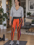 Woman wearing the Sunset Fusion High-Waisted Yoga Leggings with the Vantacore V emblem on the hip – front view