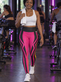 Woman wearing the Neon Magenta Inferno High-Waisted Yoga Leggings with the Vantacore V emblem on the hip – front view