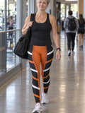 Woman wearing the Inferno Strike High-Waisted Yoga Leggings with the Vantacore V emblem on the hip – front view