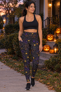 Halloween Midnight Pumpkin Spiderweb leggings with pockets worn on a model