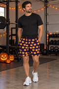 Men's Halloween Witching Purple Jack-O'-Lantern athletic multipurpose shorts worn on a model