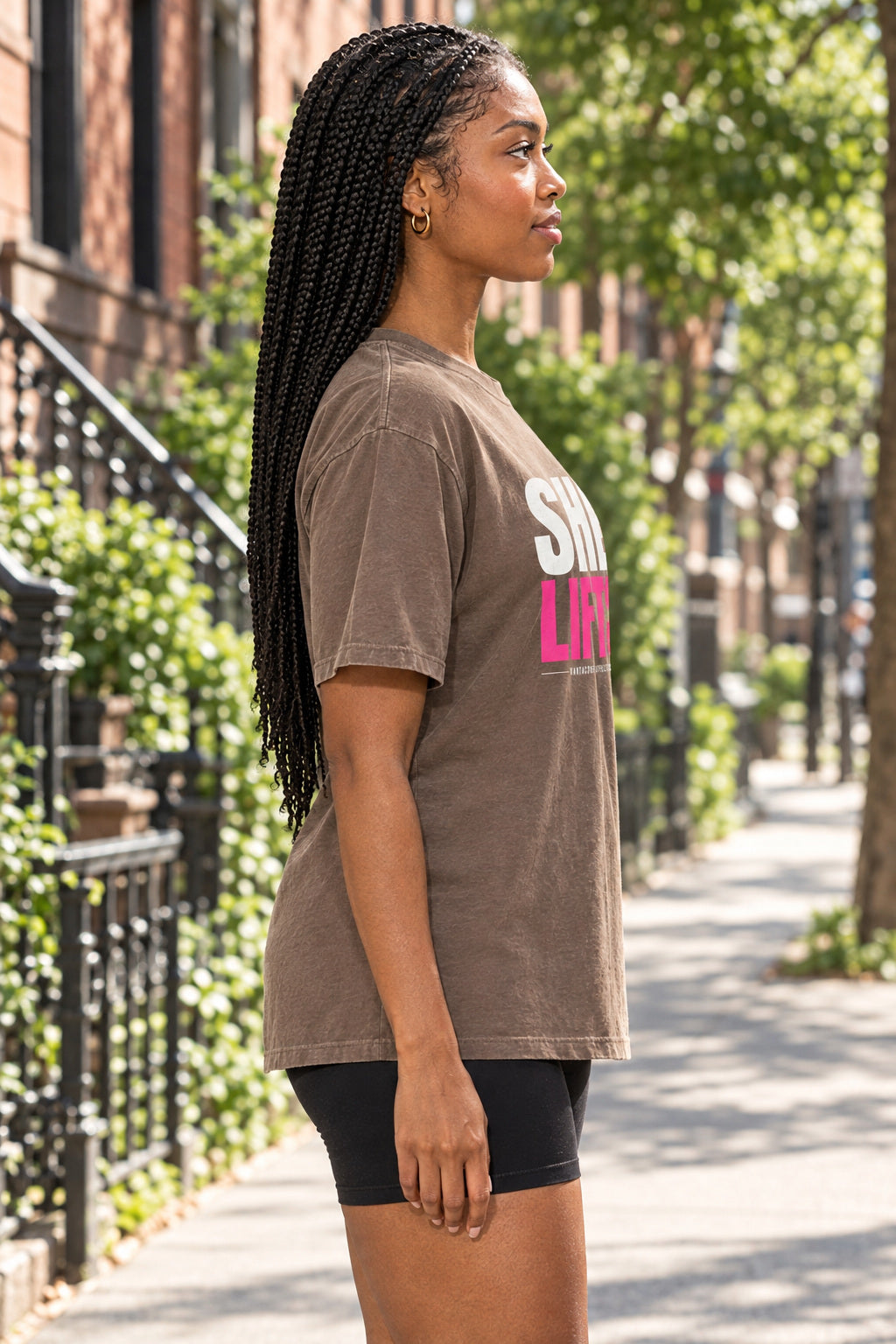 She Lifts | Women's Garment-Dyed Graphic Tee, AI-generated side-profile product mockup on a fictional adult model