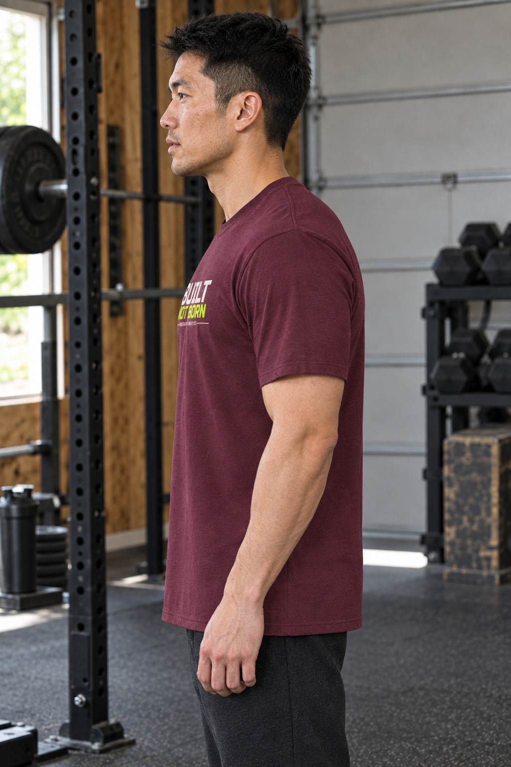Built Not Born | Men's Graphic Gym T-Shirt, AI-generated side-profile product mockup on a fictional adult model