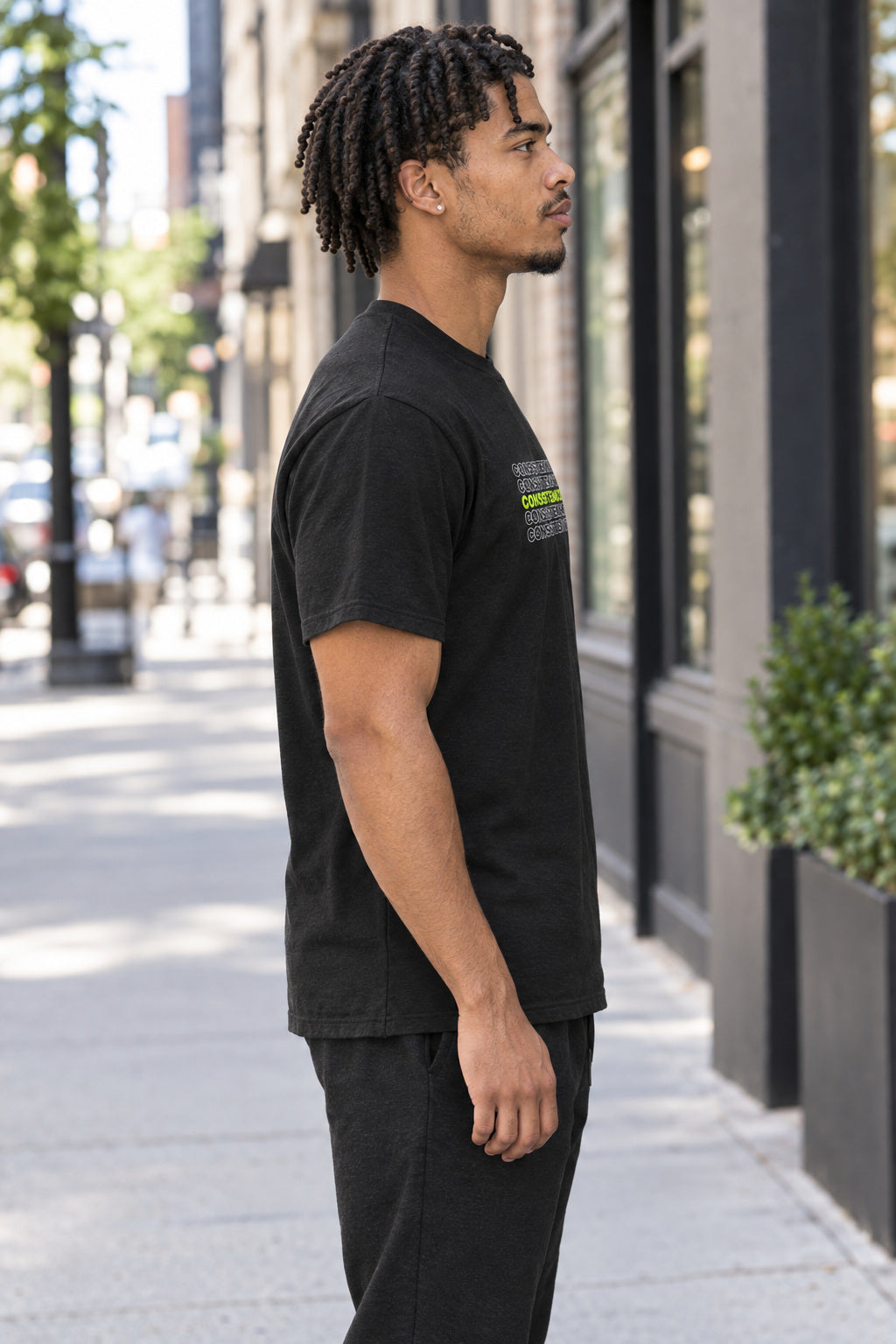 Consistency Wins | Men's Graphic Gym T-Shirt, AI-generated side-profile product mockup on a fictional adult model