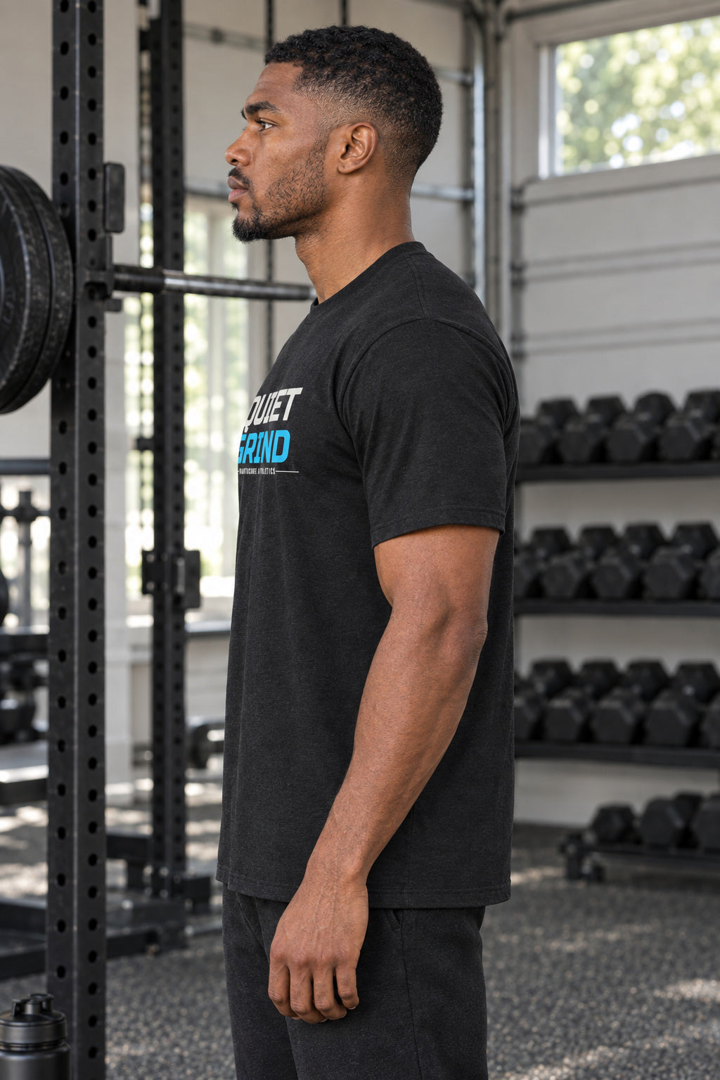 Quiet Grind | Men's Graphic Gym T-Shirt, AI-generated side-profile product mockup on a fictional adult model