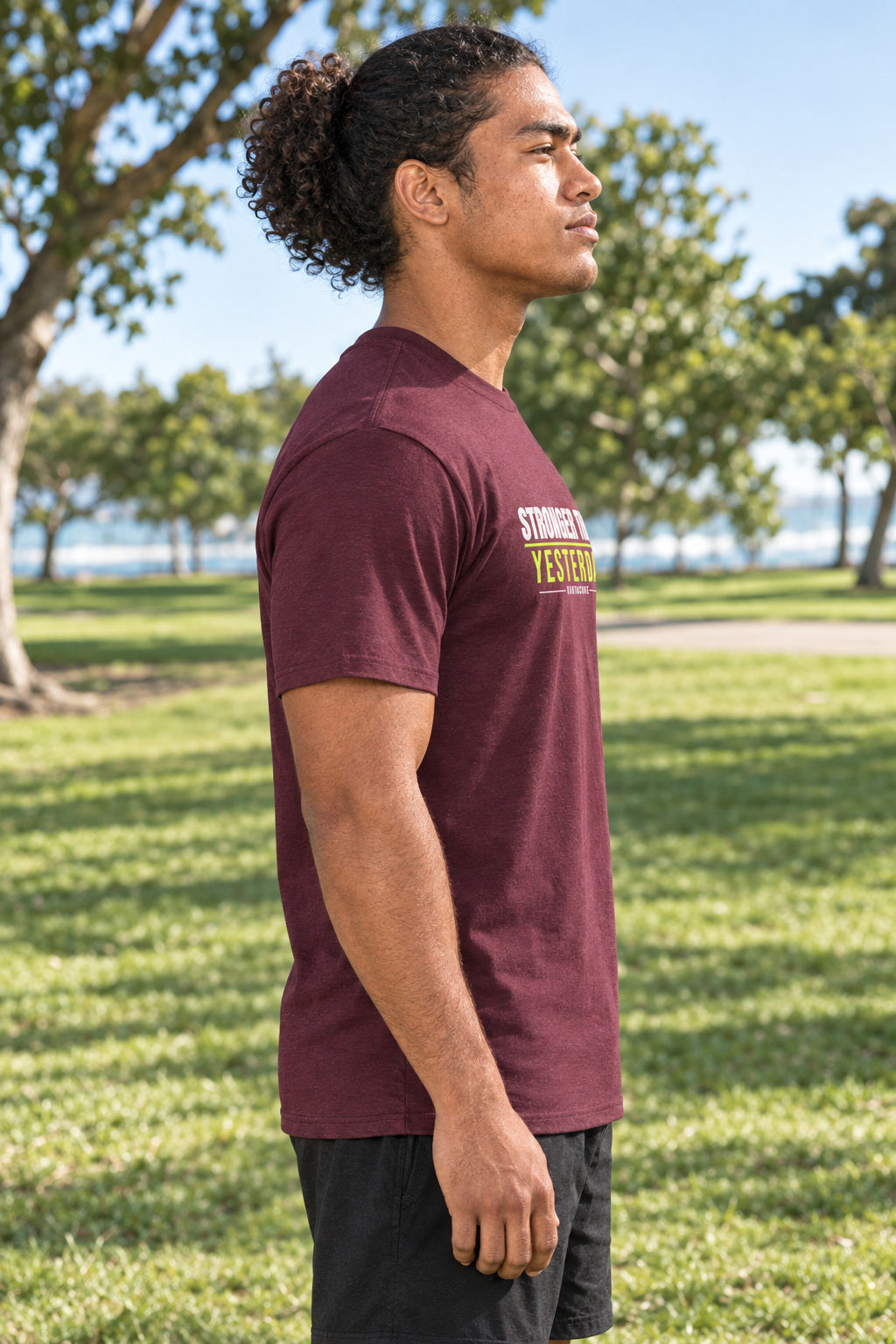 Stronger Than Yesterday | Men's Graphic Gym T-Shirt, AI-generated side-profile product mockup on a fictional adult model