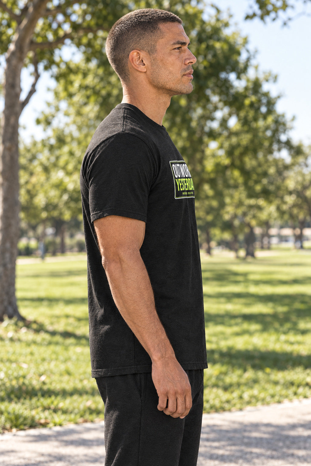 Outwork Yesterday | Men's Graphic Gym T-Shirt, AI-generated side-profile product mockup on a fictional adult model