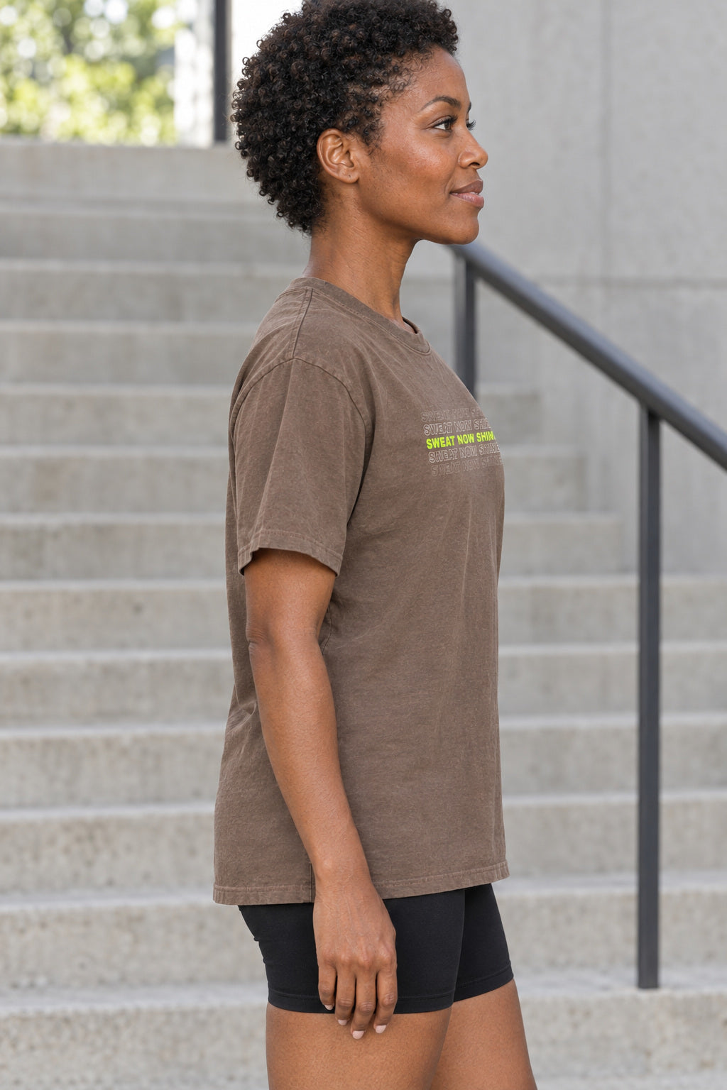 Sweat Now Shine Later | Women's Garment-Dyed Graphic Tee, AI-generated side-profile product mockup on a fictional adult model