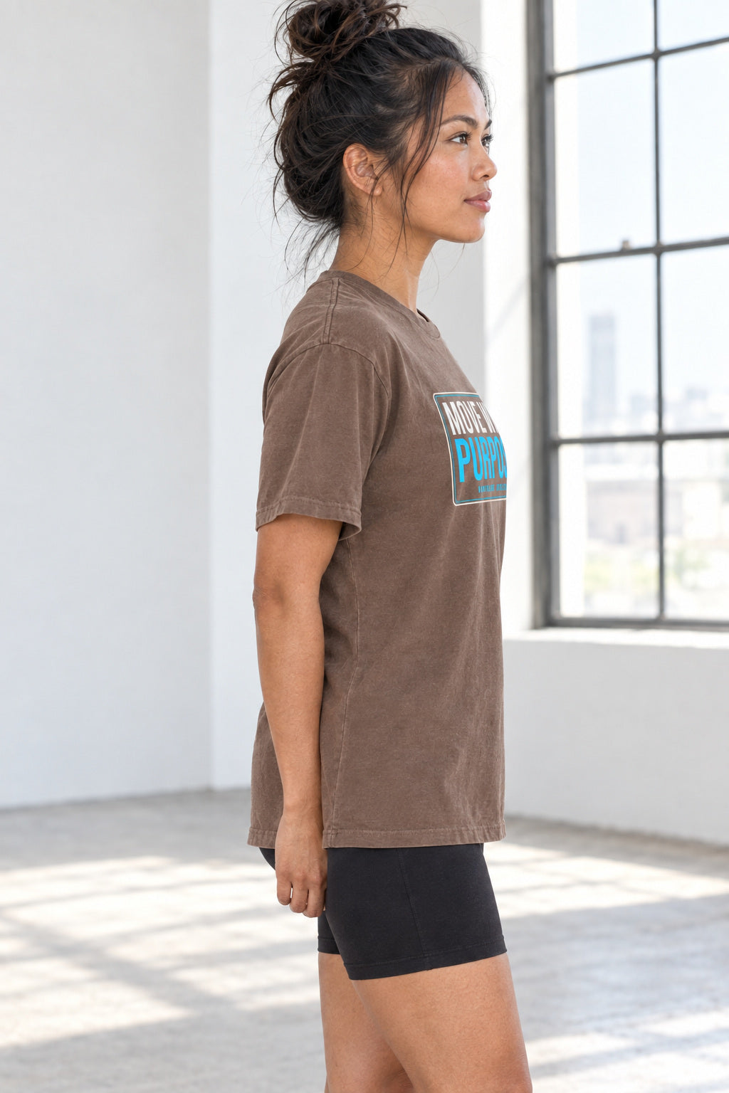 Move With Purpose | Women's Garment-Dyed Graphic Tee, AI-generated side-profile product mockup on a fictional adult model