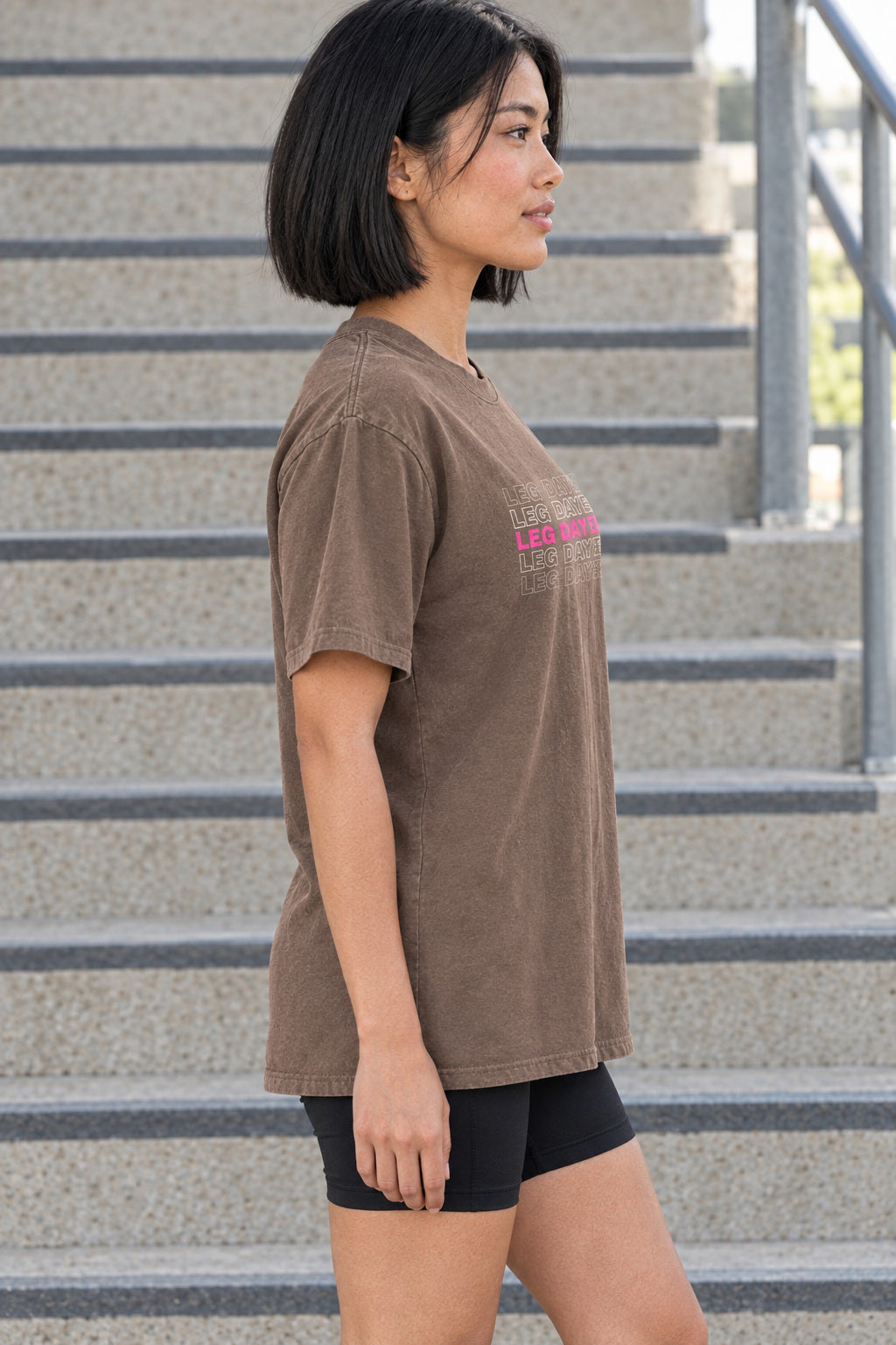 Leg Day Energy | Women's Garment-Dyed Graphic Tee, AI-generated side-profile product mockup on a fictional adult model