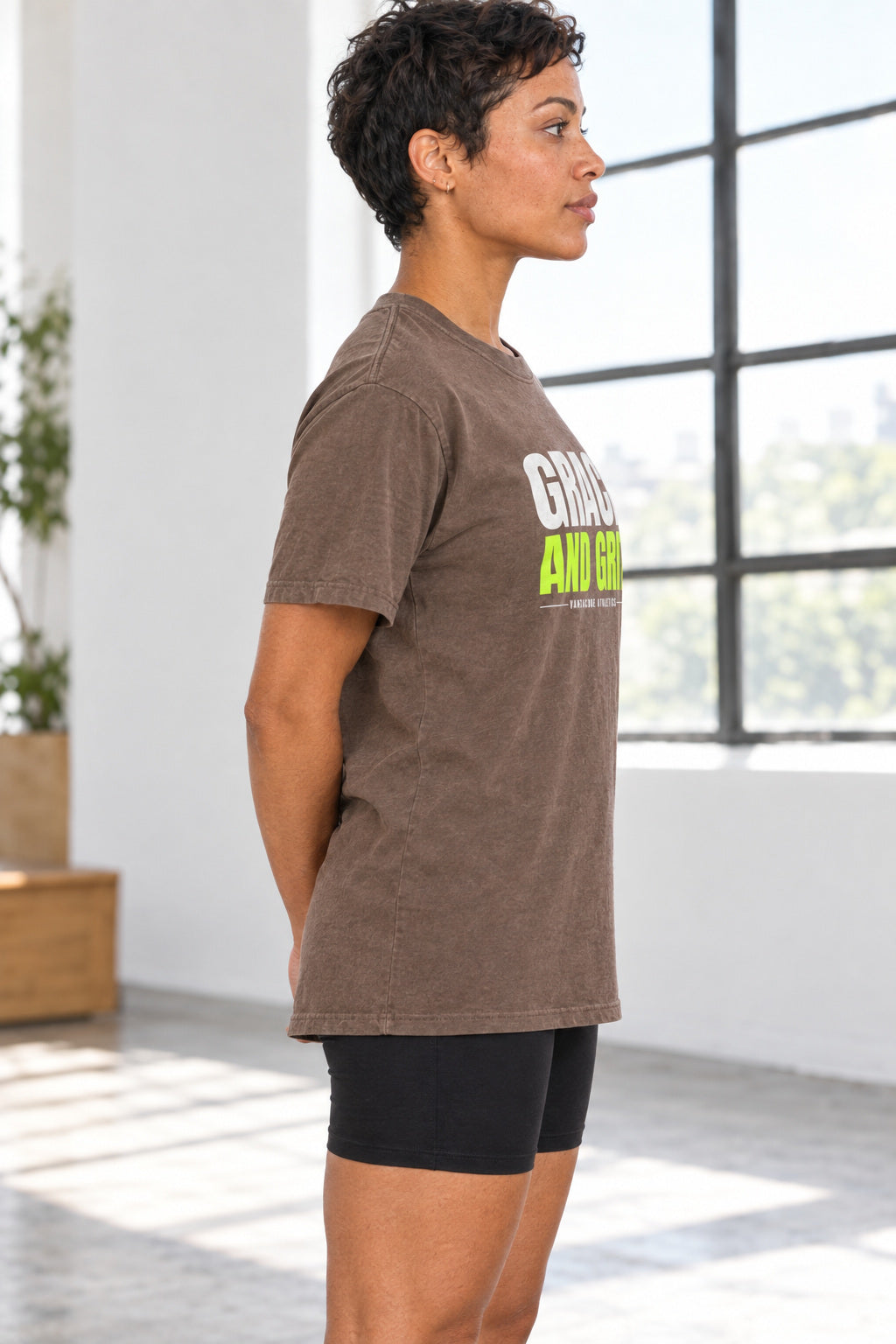 Grace And Grit | Women's Garment-Dyed Graphic Tee, AI-generated side-profile product mockup on a fictional adult model