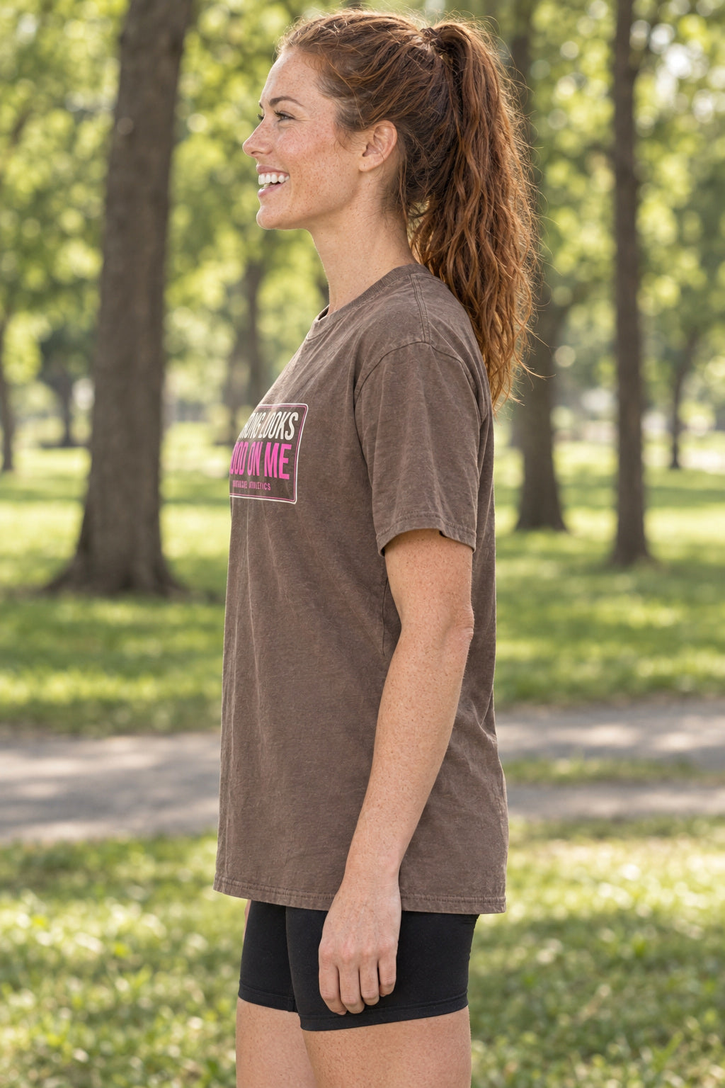 Strong Looks Good On Me | Women's Garment-Dyed Graphic Tee, AI-generated side-profile product mockup on a fictional adult model