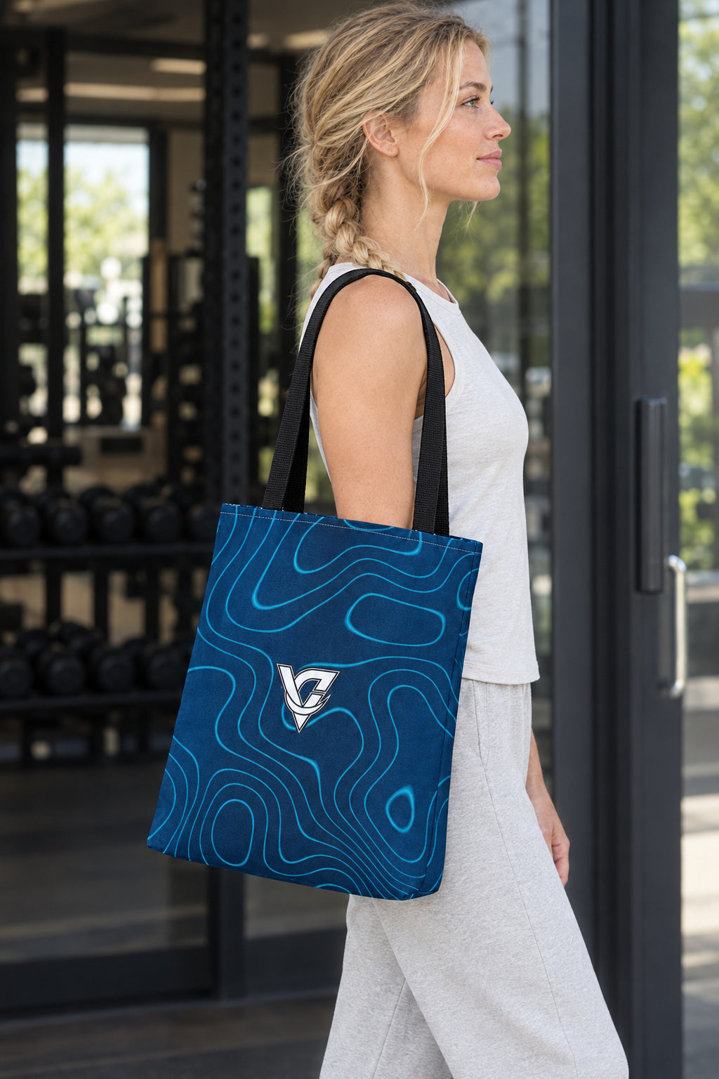 Ocean Topo Tote Bag — All-Over Print Gym & Everyday Tote, AI-generated side-profile product mockup on a fictional adult model