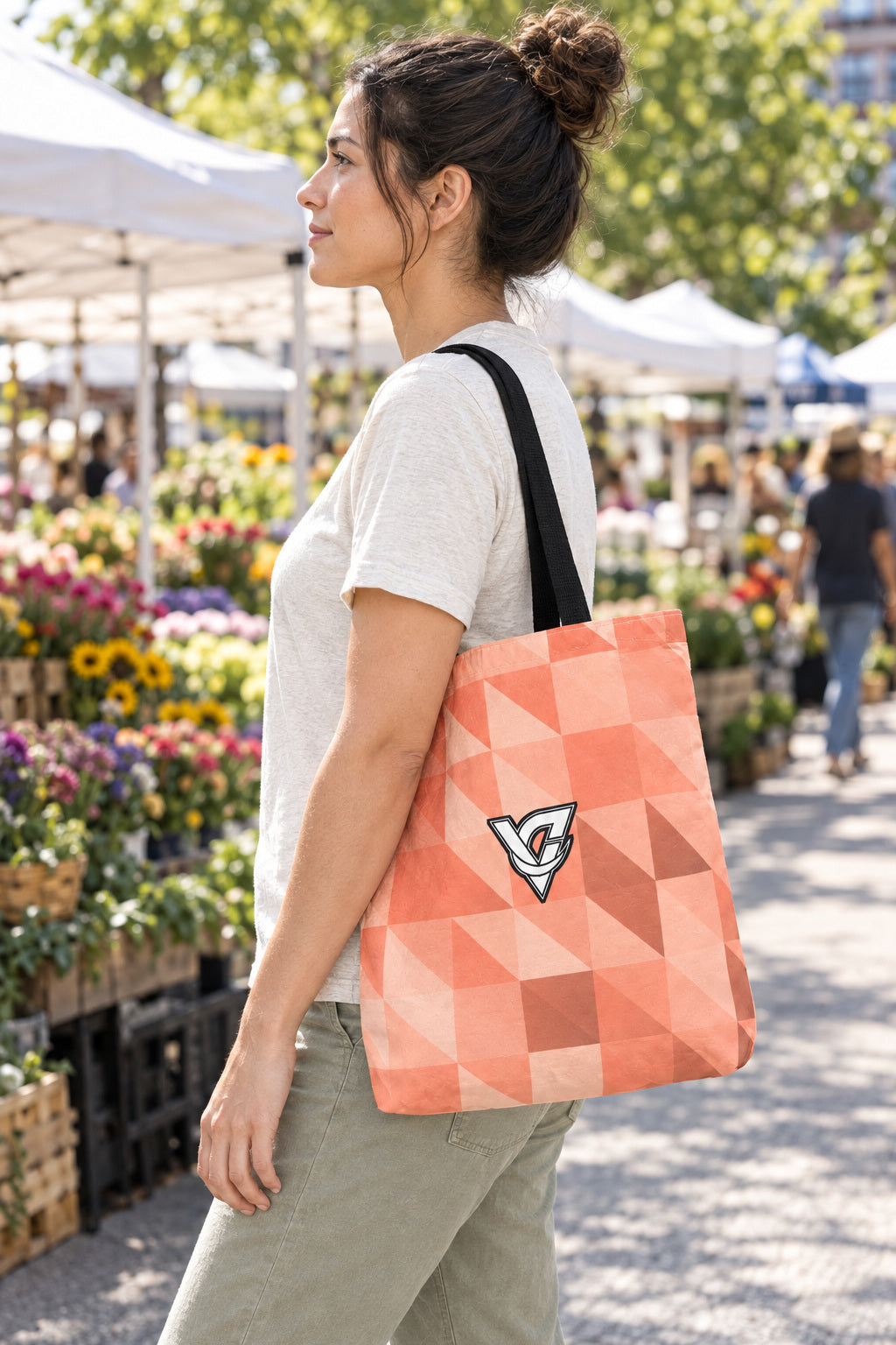Peach Low-Poly Tote Bag — All-Over Print Gym & Everyday Tote, AI-generated side-profile product mockup on a fictional adult model
