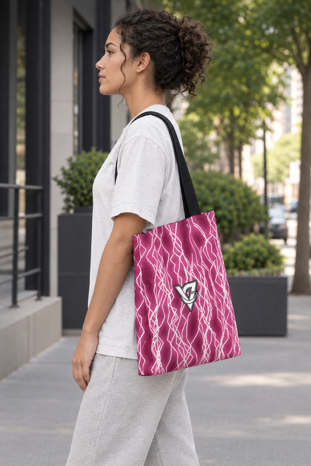 Hot Pink Lightning Tote Bag — All-Over Print Gym & Everyday Tote, AI-generated side-profile product mockup on a fictional adult model