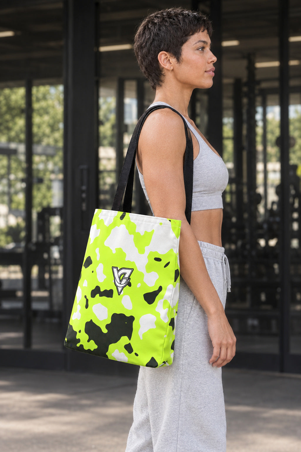Volt Magma Tote Bag — All-Over Print Gym & Everyday Tote, AI-generated side-profile product mockup on a fictional adult model