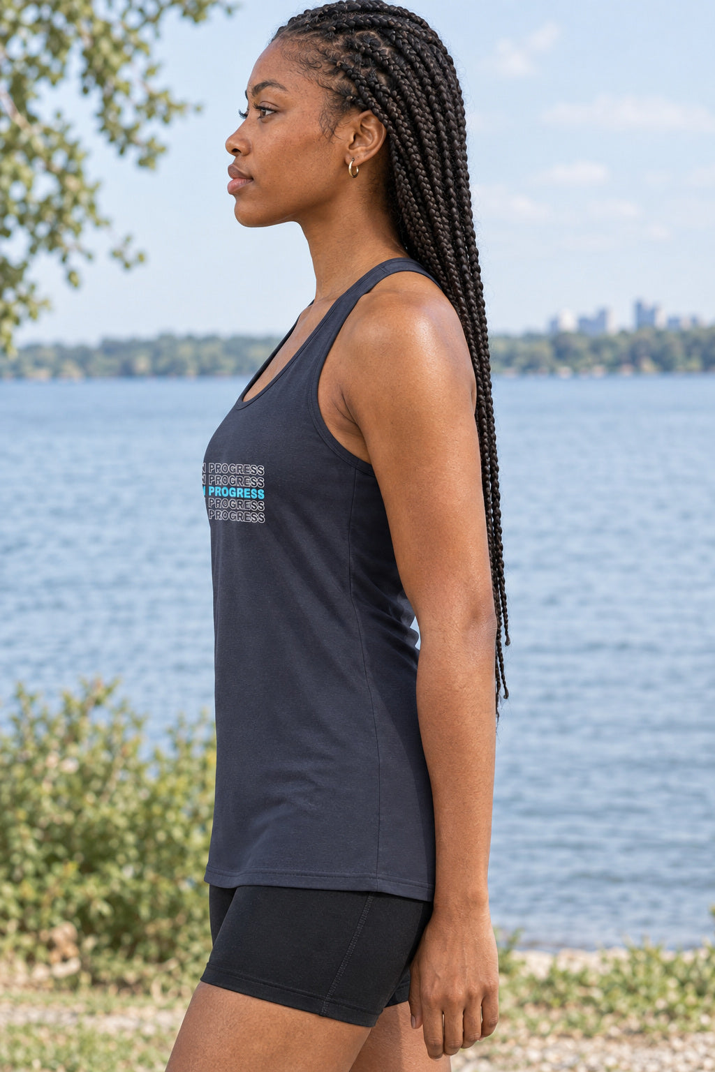 Work In Progress | Women's Performance Racerback Tank, AI-generated side-profile product mockup on a fictional adult model