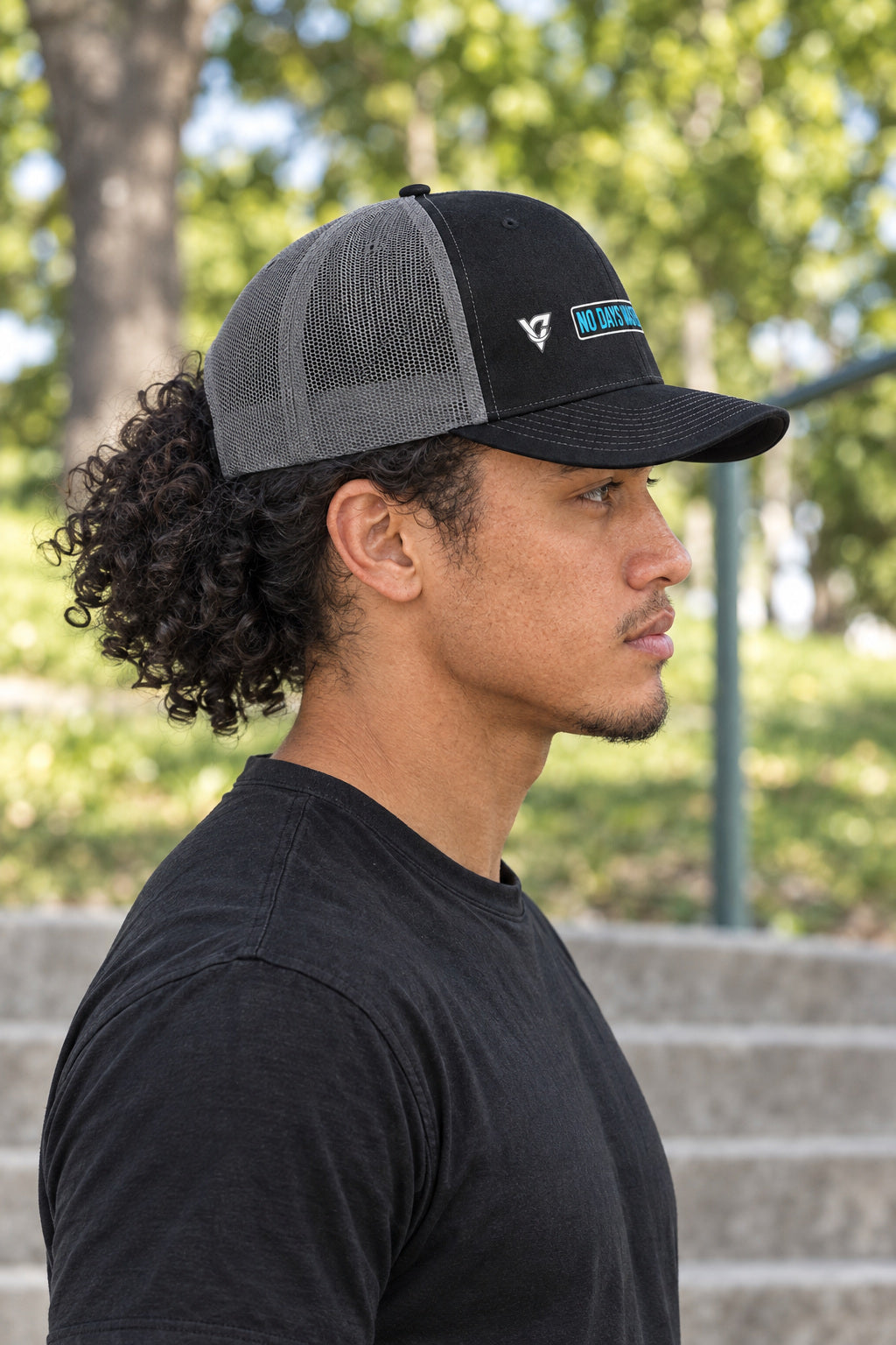No Days Wasted Trucker Cap — Vantacore Snapback Hat, AI-generated side-profile product mockup on a fictional adult model