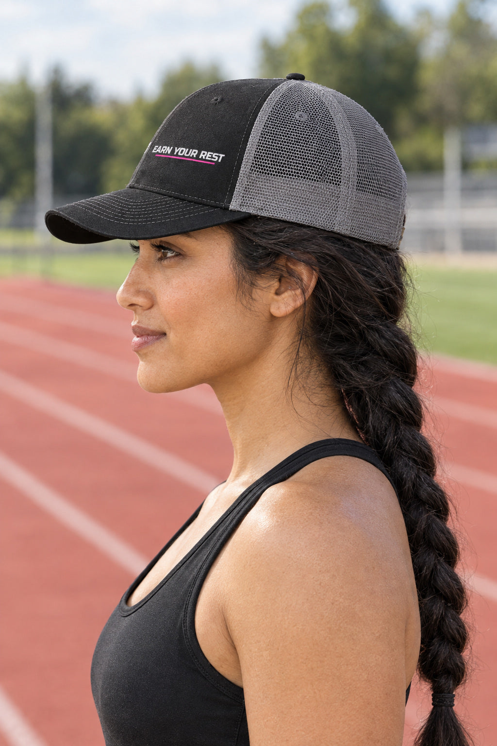 Earn Your Rest Trucker Cap — Vantacore Snapback Hat, AI-generated side-profile product mockup on a fictional adult model