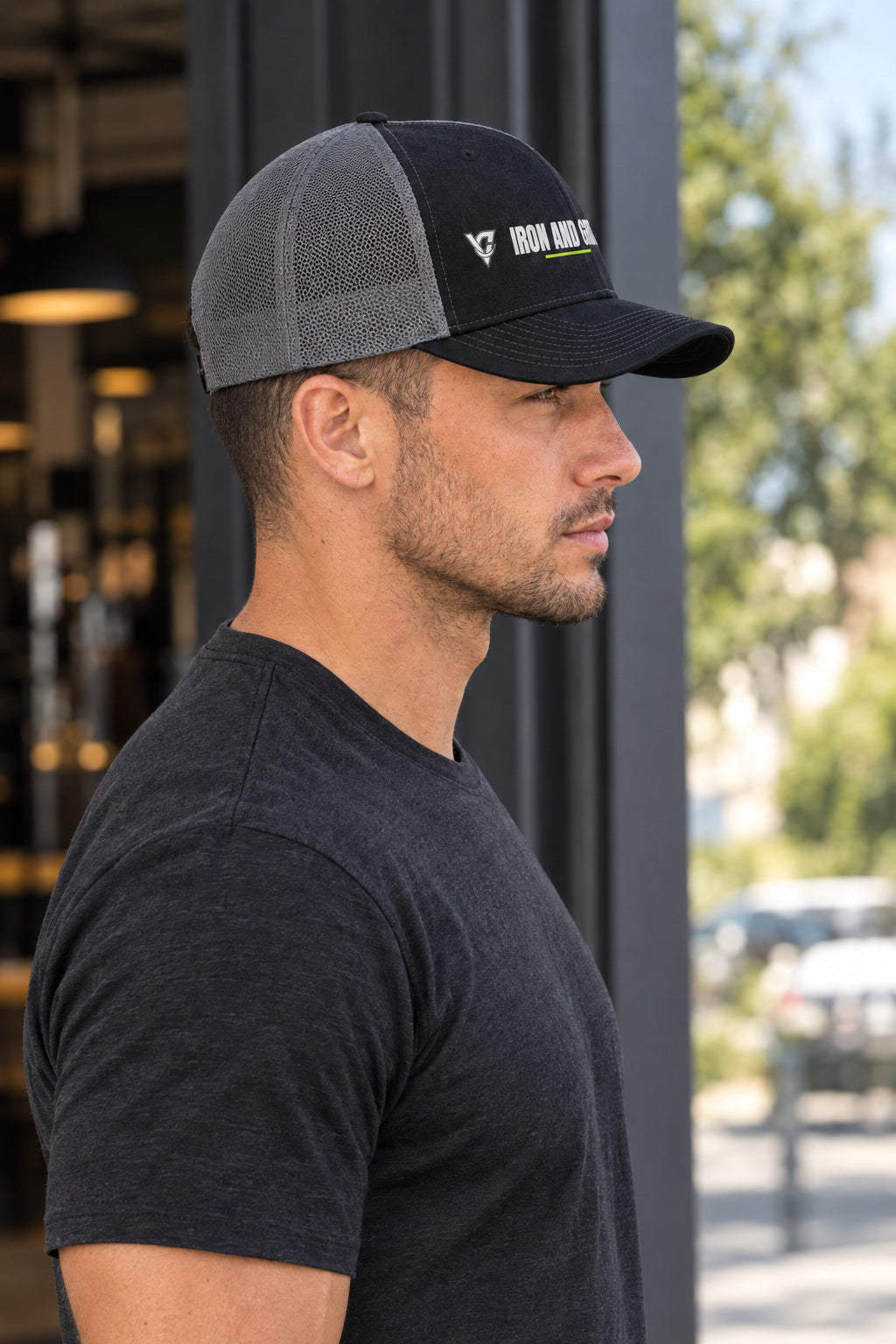 Iron And Grit Trucker Cap — Vantacore Snapback Hat, AI-generated side-profile product mockup on a fictional adult model