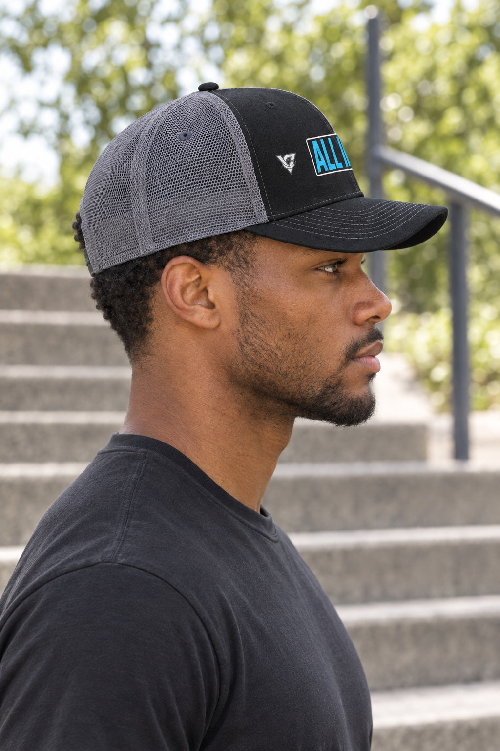 All In Trucker Cap — Vantacore Snapback Hat, AI-generated side-profile product mockup on a fictional adult model