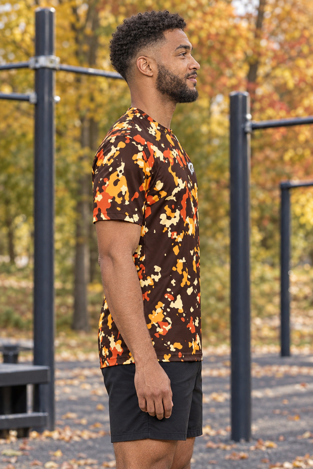 Golden Hour Splatter Multipurpose Athletic Shirt, AI-generated side-profile product mockup on a fictional adult model