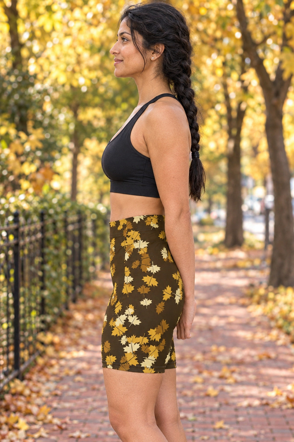 Harvest Gold Falling Leaves Women's Biker Shorts — High-Waist Workout Shorts, AI-generated side-profile product mockup on a fictional adult model