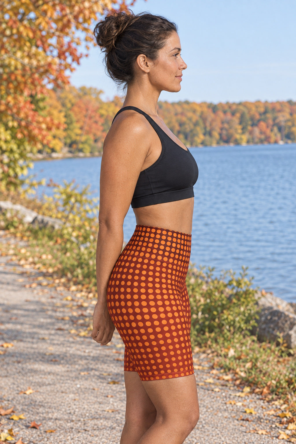 Sunset Orchard Halftone Women's Biker Shorts — High-Waist Workout Shorts, AI-generated side-profile product mockup on a fictional adult model