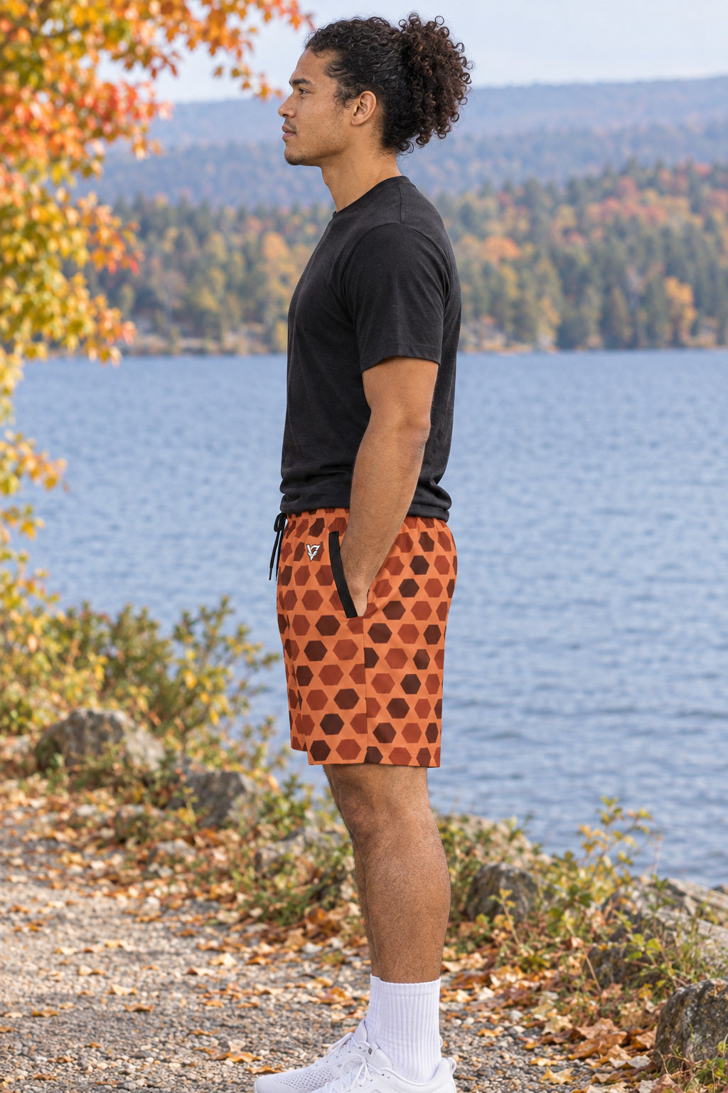 Men's Terracotta Hex Grid Performance Jogger Athletic Shorts with Pockets, AI-generated side-profile product mockup on a fictional adult model