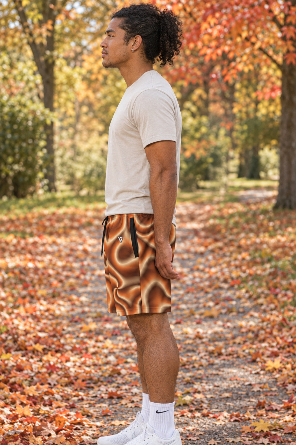 Men's Cinnamon Tie-Dye Performance Jogger Athletic Shorts with Pockets, AI-generated side-profile product mockup on a fictional adult model