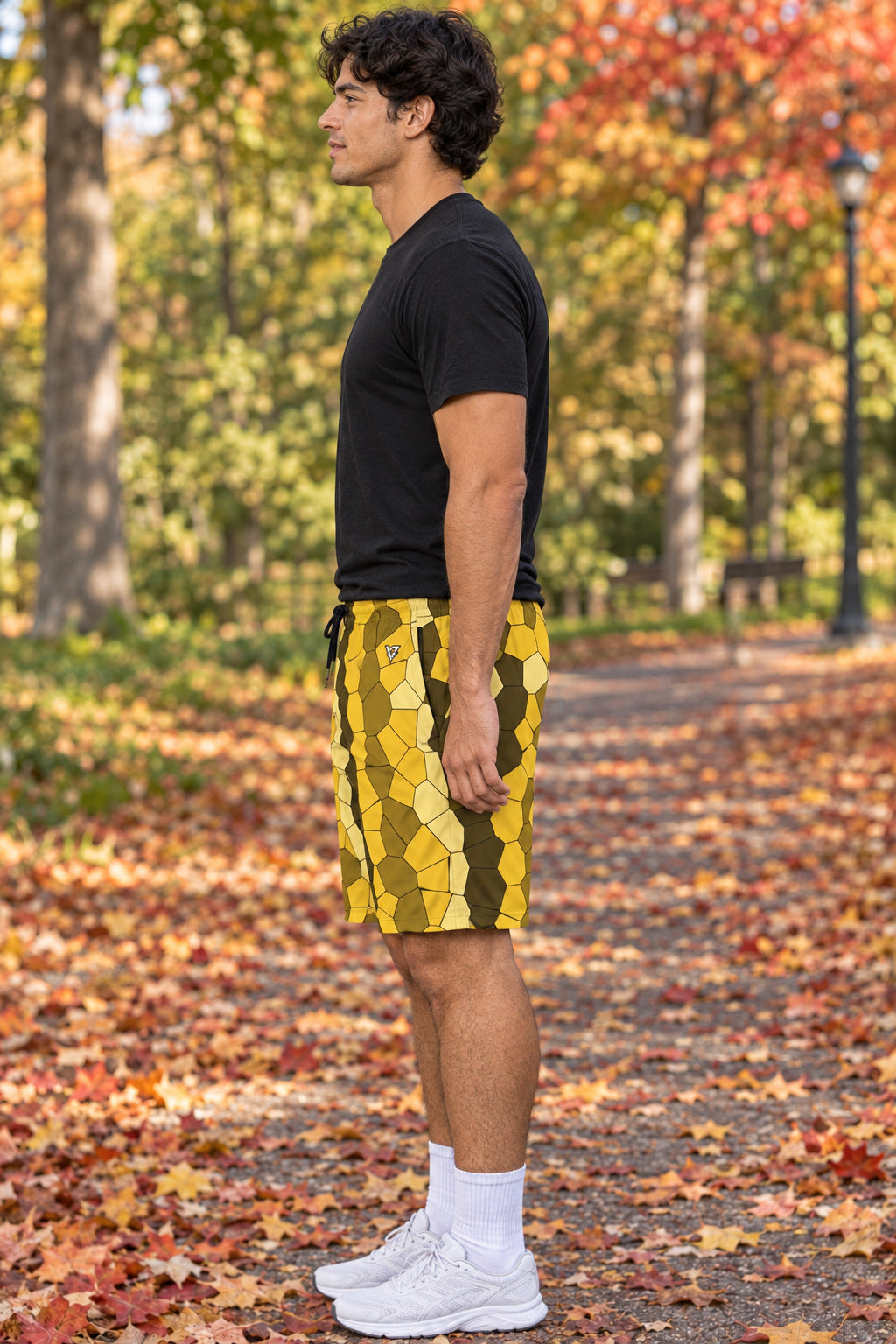 Men's Mustard Mosaic Performance Jogger Athletic Shorts with Pockets, AI-generated side-profile product mockup on a fictional adult model