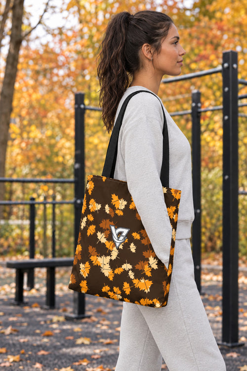 Amber Falling Leaves Tote Bag — All-Over Print Gym & Everyday Tote, AI-generated side-profile product mockup on a fictional adult model