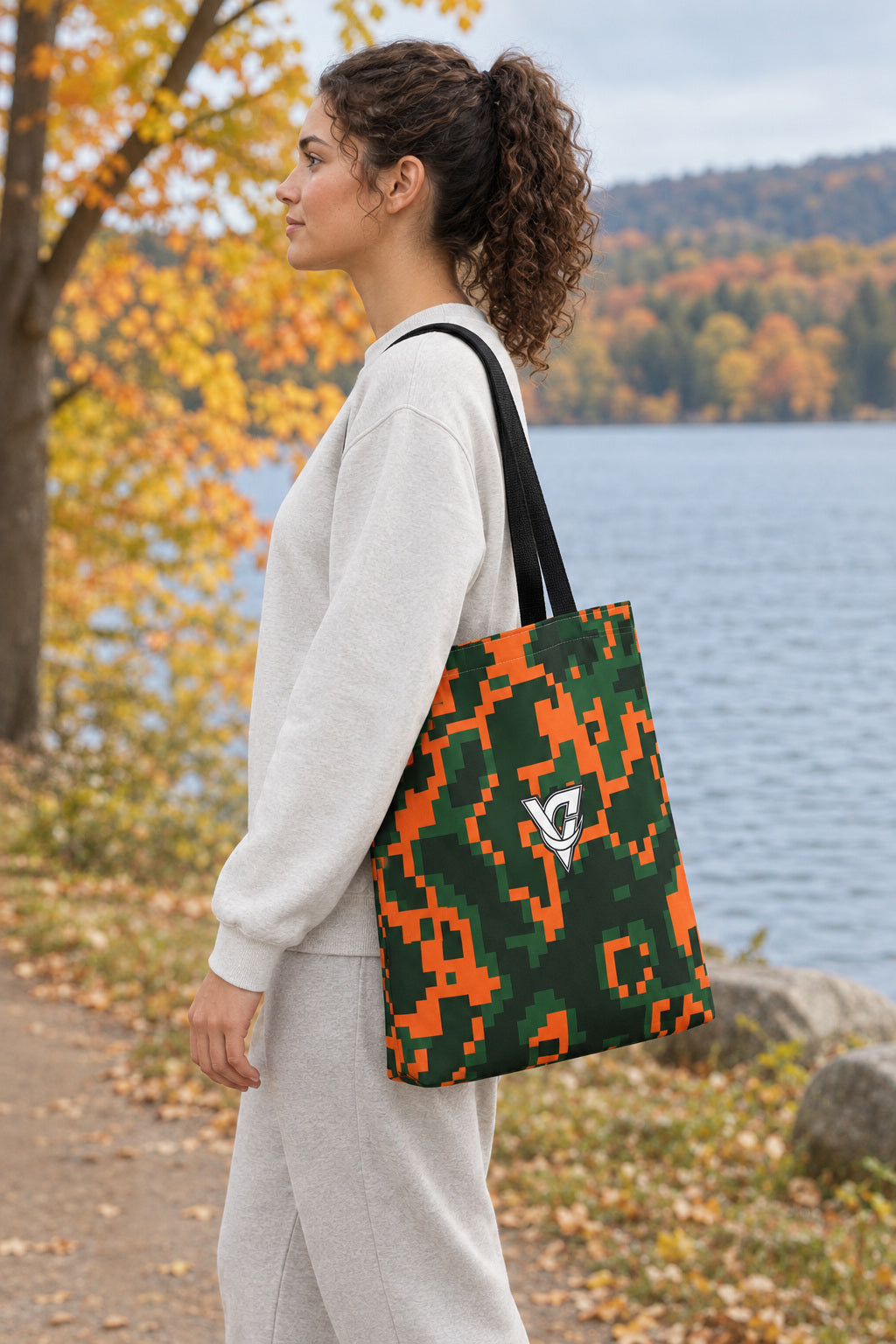 Evergreen Ember Digital Camo Tote Bag — All-Over Print Gym & Everyday Tote, AI-generated side-profile product mockup on a fictional adult model
